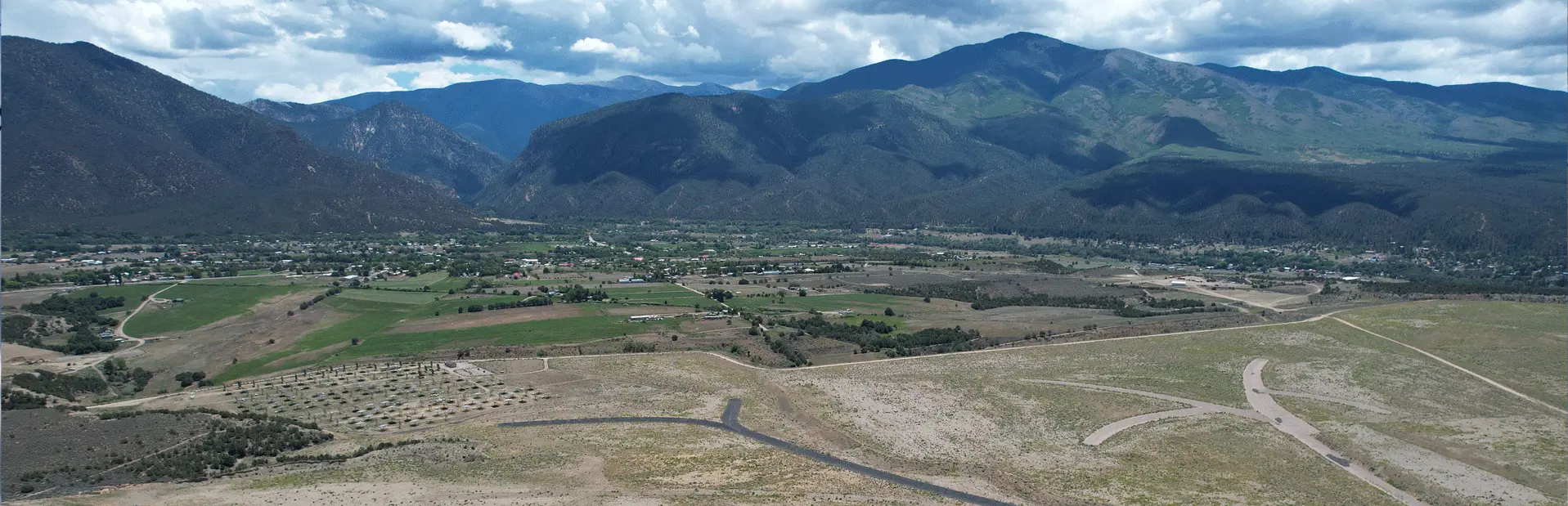 Arial shot of the town of Questa with the mountains in the back